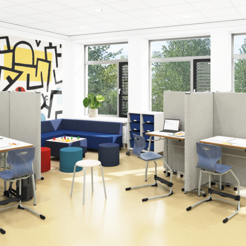 Lernbereich einer Grundschule mit Einzelarbeitsplätzen, einer Sofaecke und einer Tischgruppe