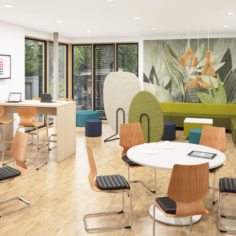 Teamraum mit runden Besprechungstischen, einem Stehtisch, einer Sofaecke und dazwischen zonierenden Akustikelementen